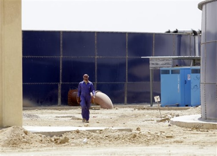 A worker walks through the nearly-complete waste water treatment site in Fallujah, Iraq, 40 miles west of Baghdad. The system is almost finished - at a cost of more than three times the original estimate and four years past the initial deadline. 